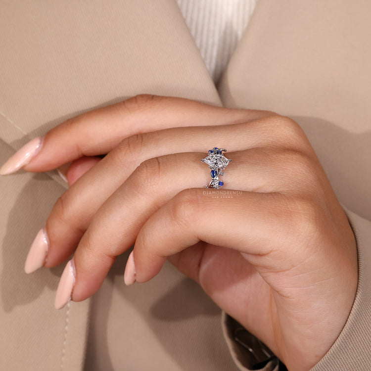 Marquise diamond ring with round tanzanite and leaf band.