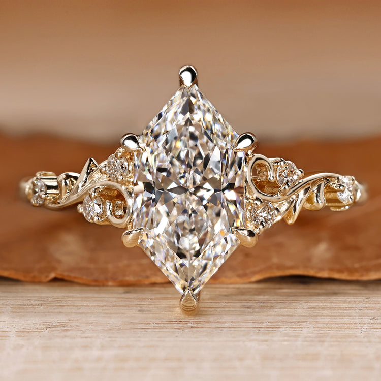 Dutch marquise diamond ring with round side stones.