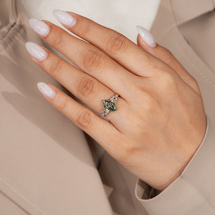 Art Deco marquise ring with engraved shank and round side stones.