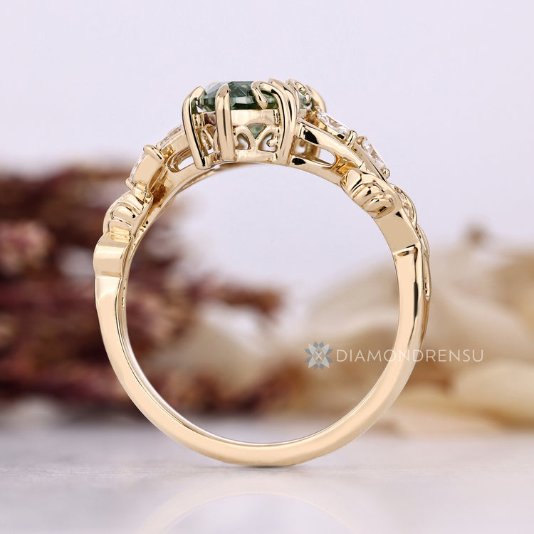 Green centre diamond ring with marquise side stone.
