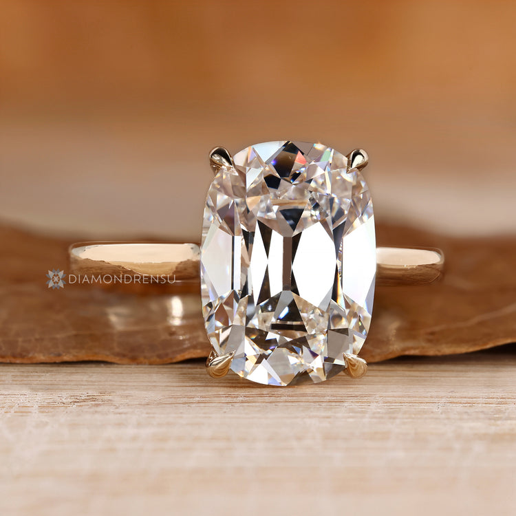 Handmade cushion diamond ring with cathedral setting.