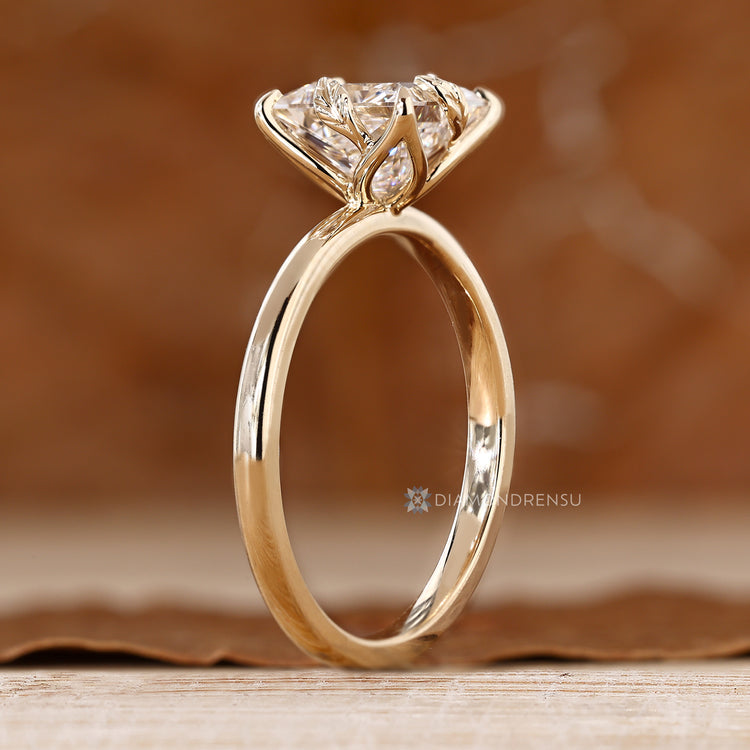 Princess cut solitaire ring with handmade tulip setting.