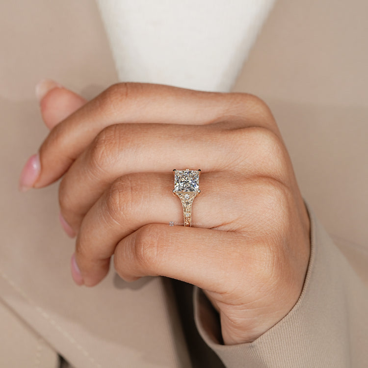 Princess cut engagement ring with ocean waves details.