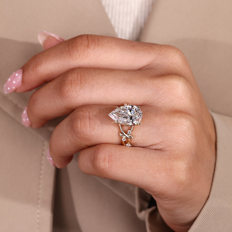 IGI certified pear cut diamond ring with cluster setting.