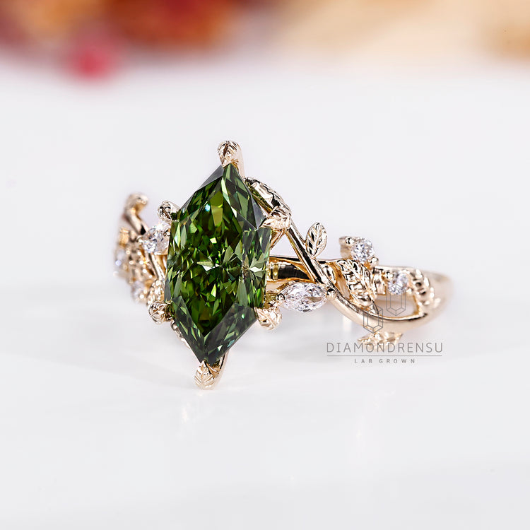 Nature inspired ring with green diamond and side stones.