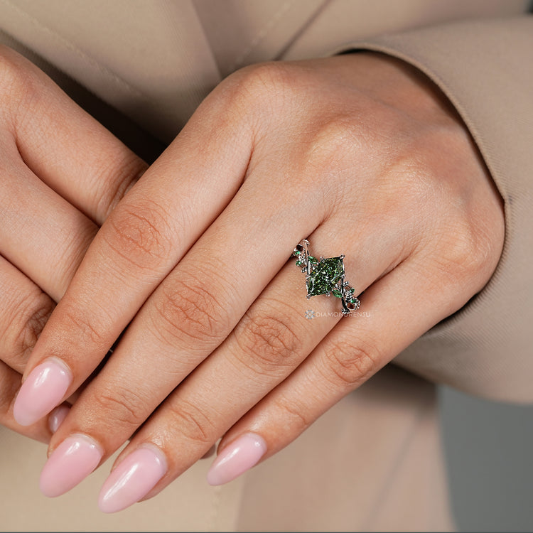 Green marquise diamond ring with six leaf prong setting.