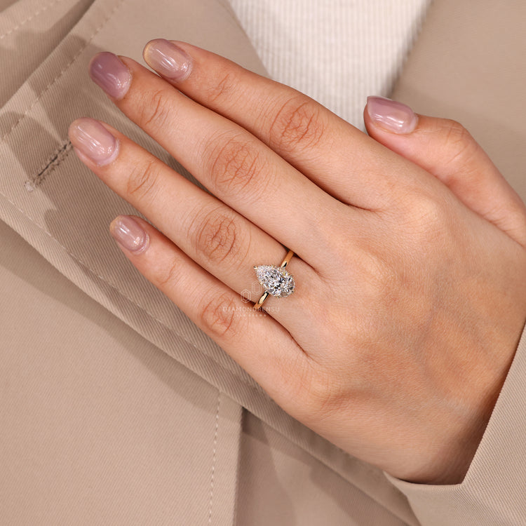 Lab grown pear diamond ring with solitaire and halo.