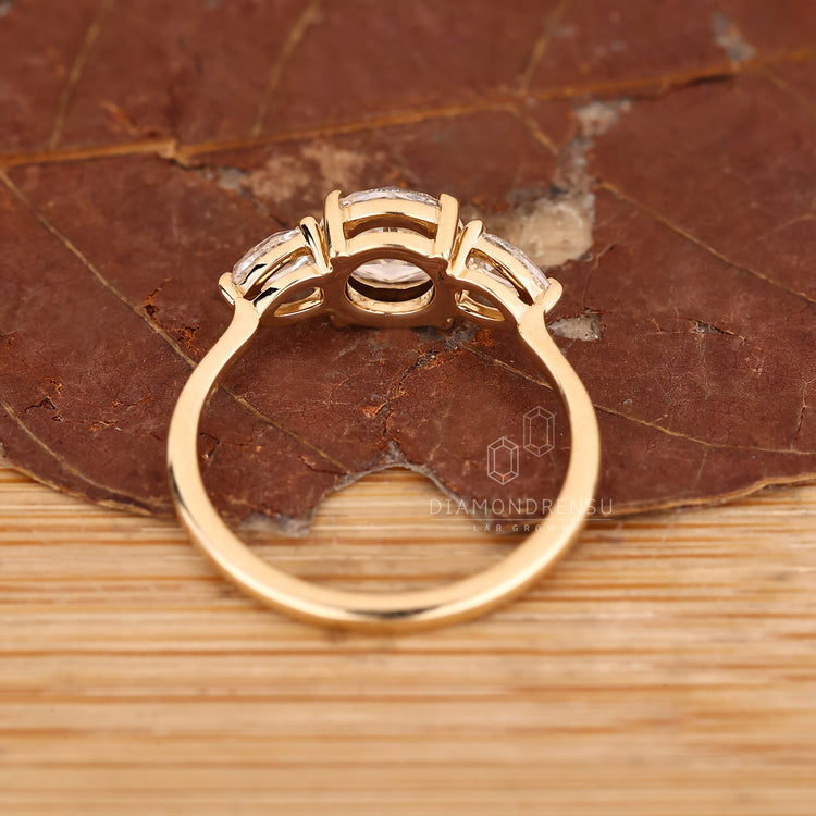 Open gallery diamond ring with pear rose cut sides.