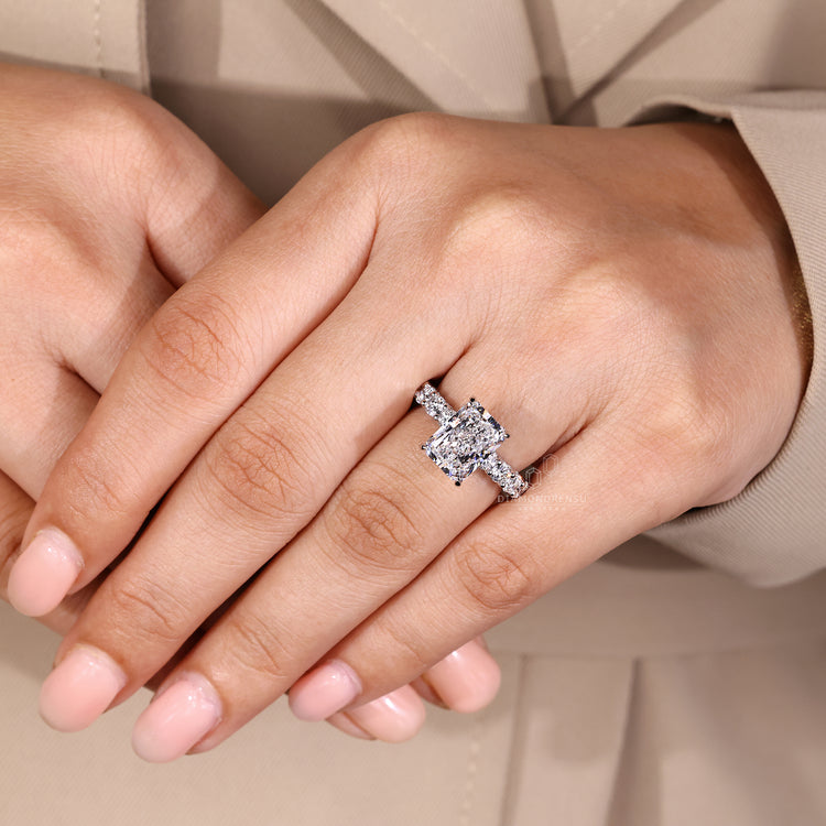 Radiant cut diamond ring with u shape pave band.