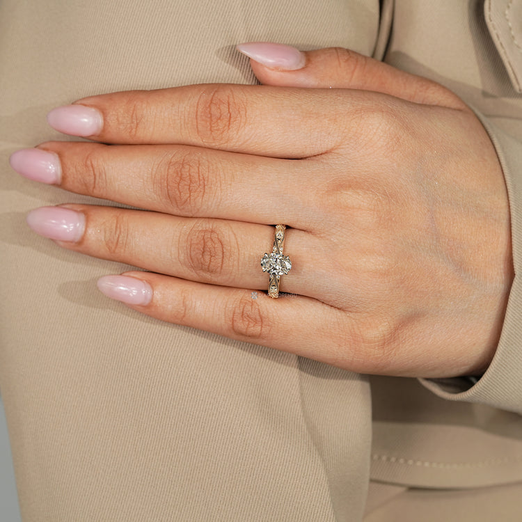 Oval engagement ring with round and marquise diamonds.