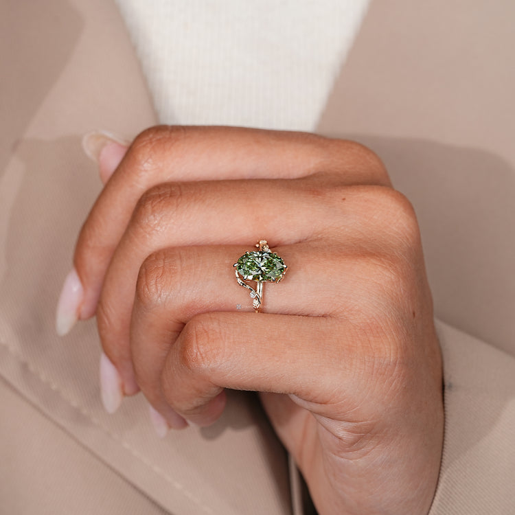 Nature inspired oval ring with green centre diamond.