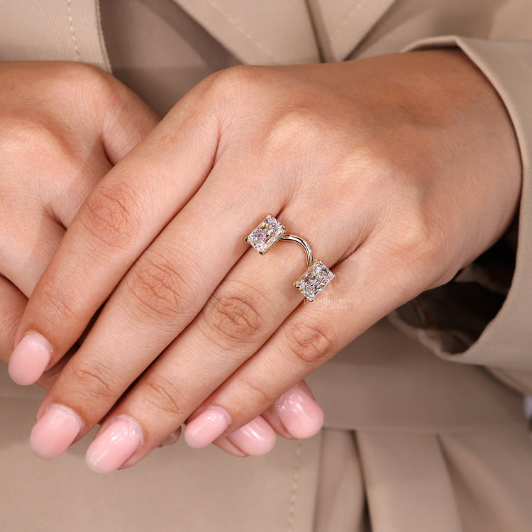 Radiant diamond ring with claw prongs and curved band.
