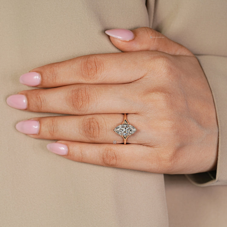 Cathedral setting marquise diamond ring with split shank.