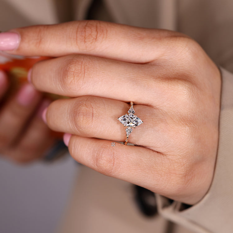 Marquise diamond ring with tapered shank and prongs.