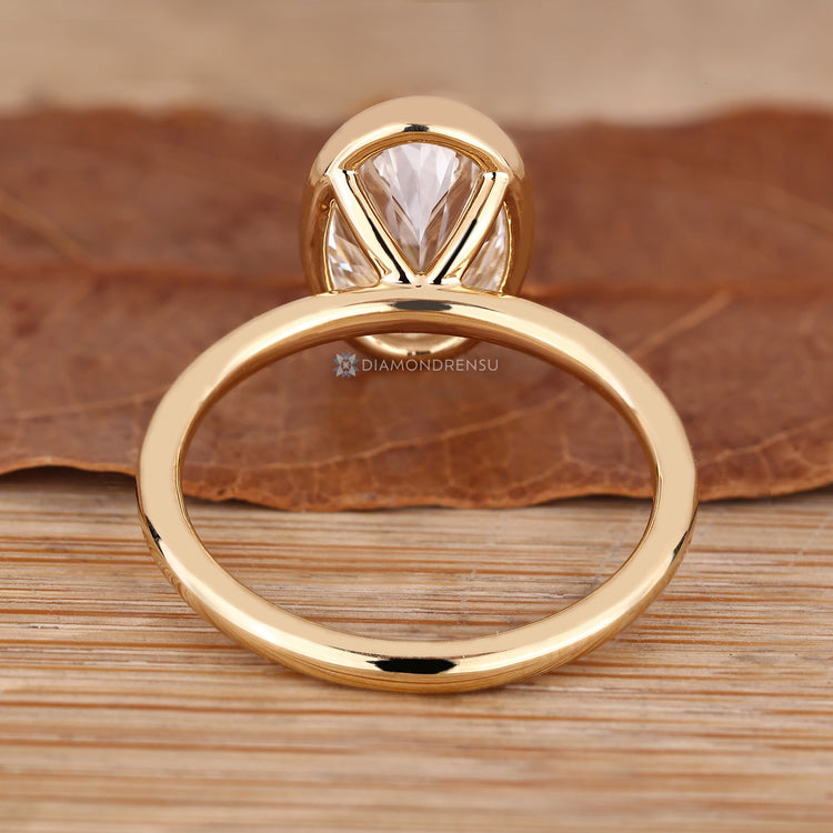 Oval diamond solitaire ring with handmade setting.
