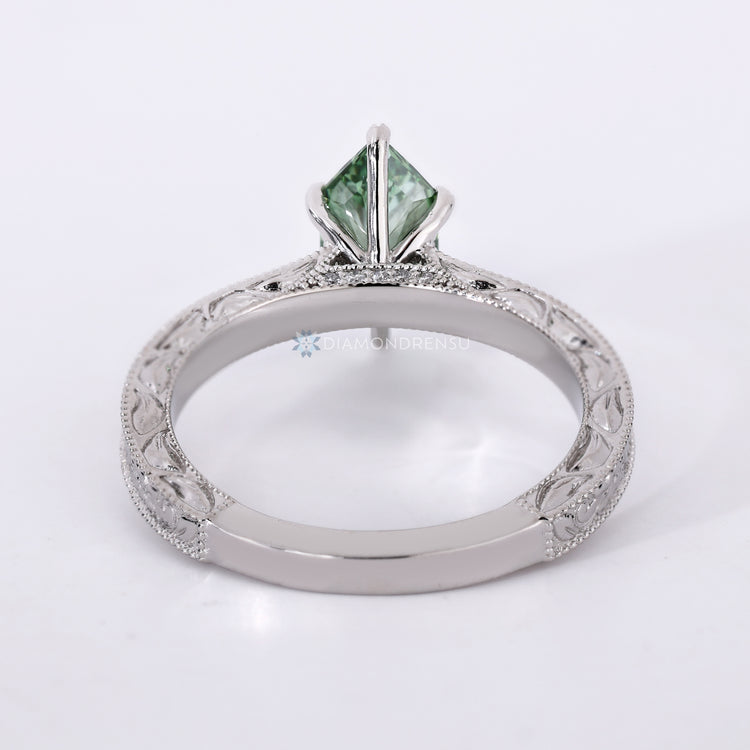 IGI certified green diamond ring with cathedral setting.