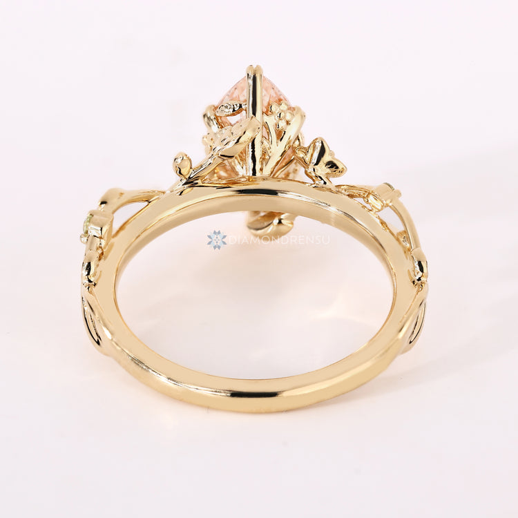 Marquise engagement ring with blue and peridot side stones.