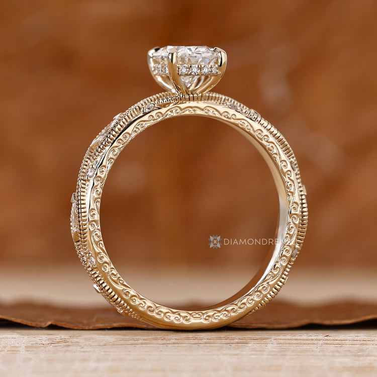 Handmade oval diamond ring with milgrain detailing.