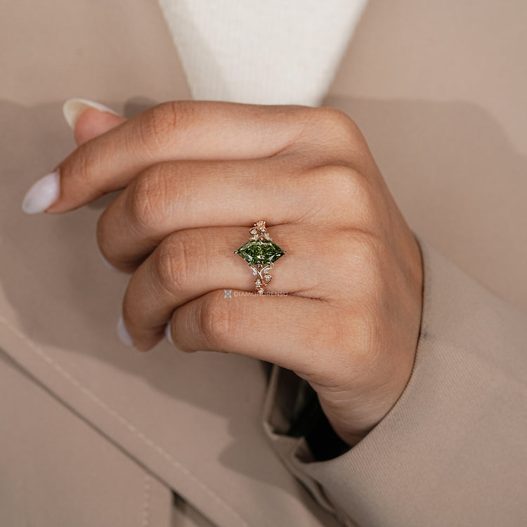 Green diamond ring with split shank and filigree details.