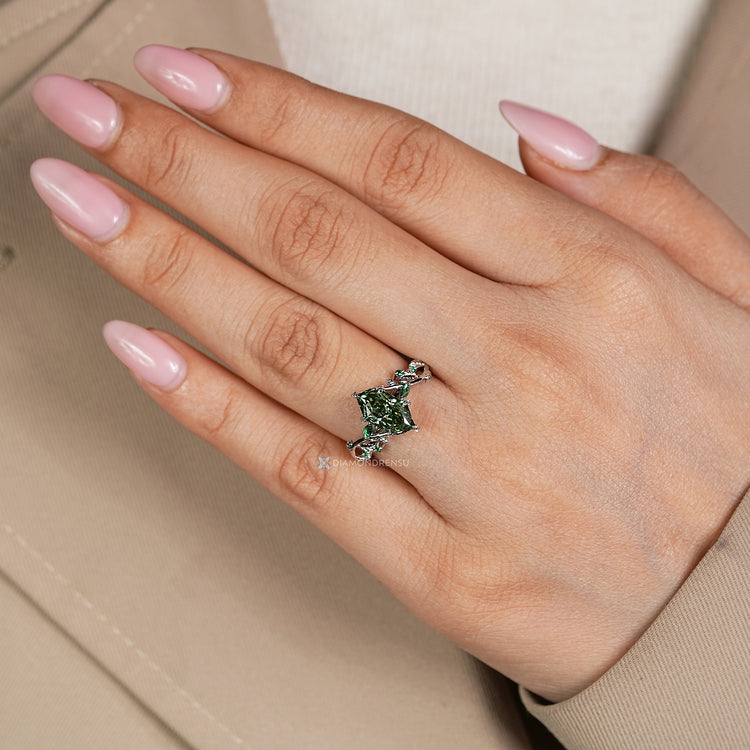 Nature inspired engagement ring with green emerald gemstones.