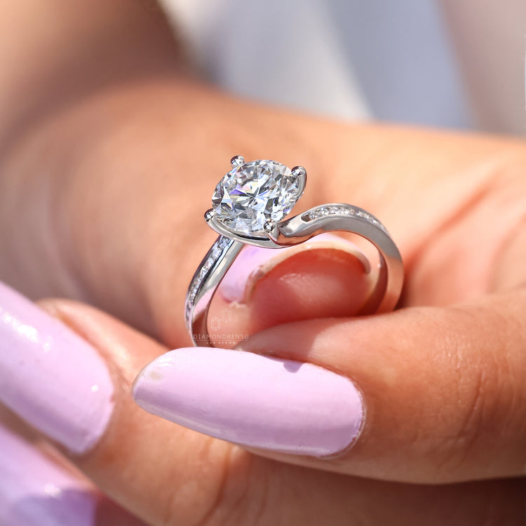 White gold engagement ring with compass prong setting.