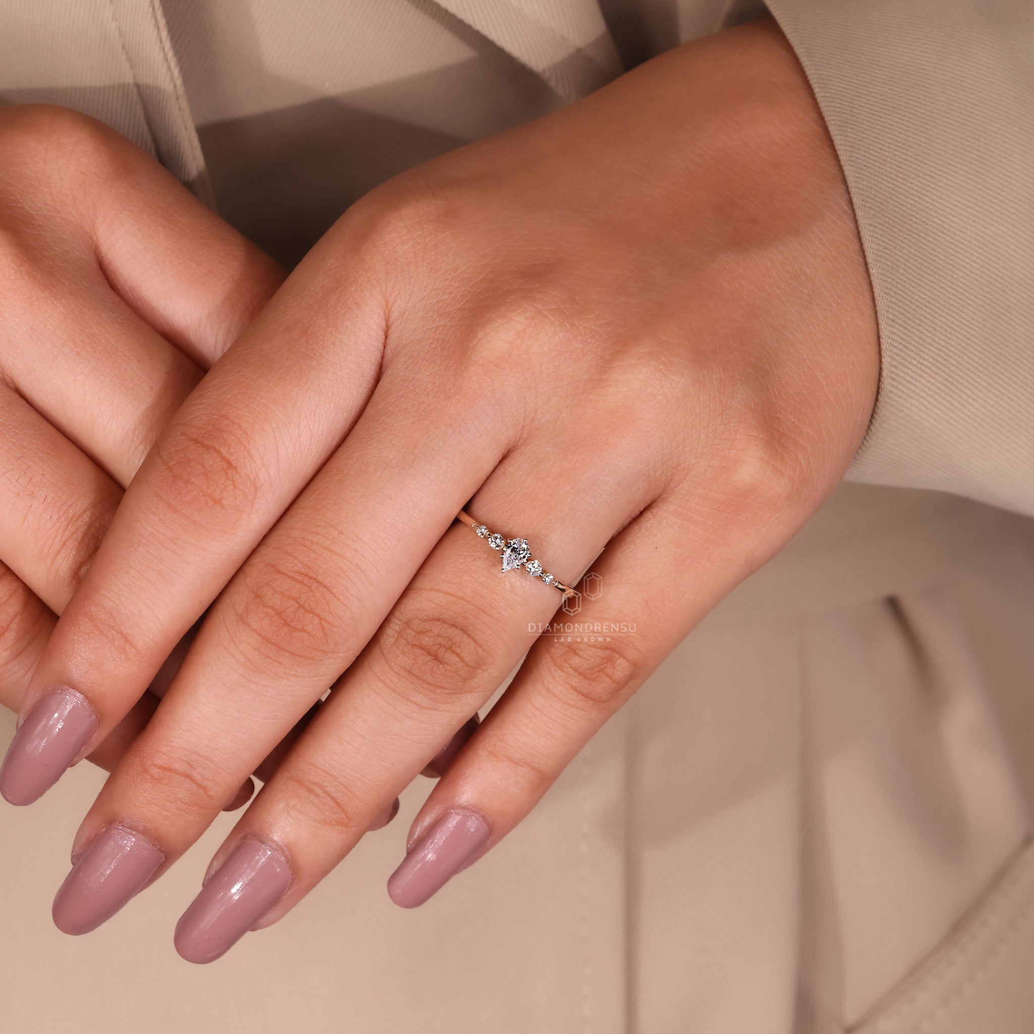 Elegant yellow gold engagement ring with teardrop diamond