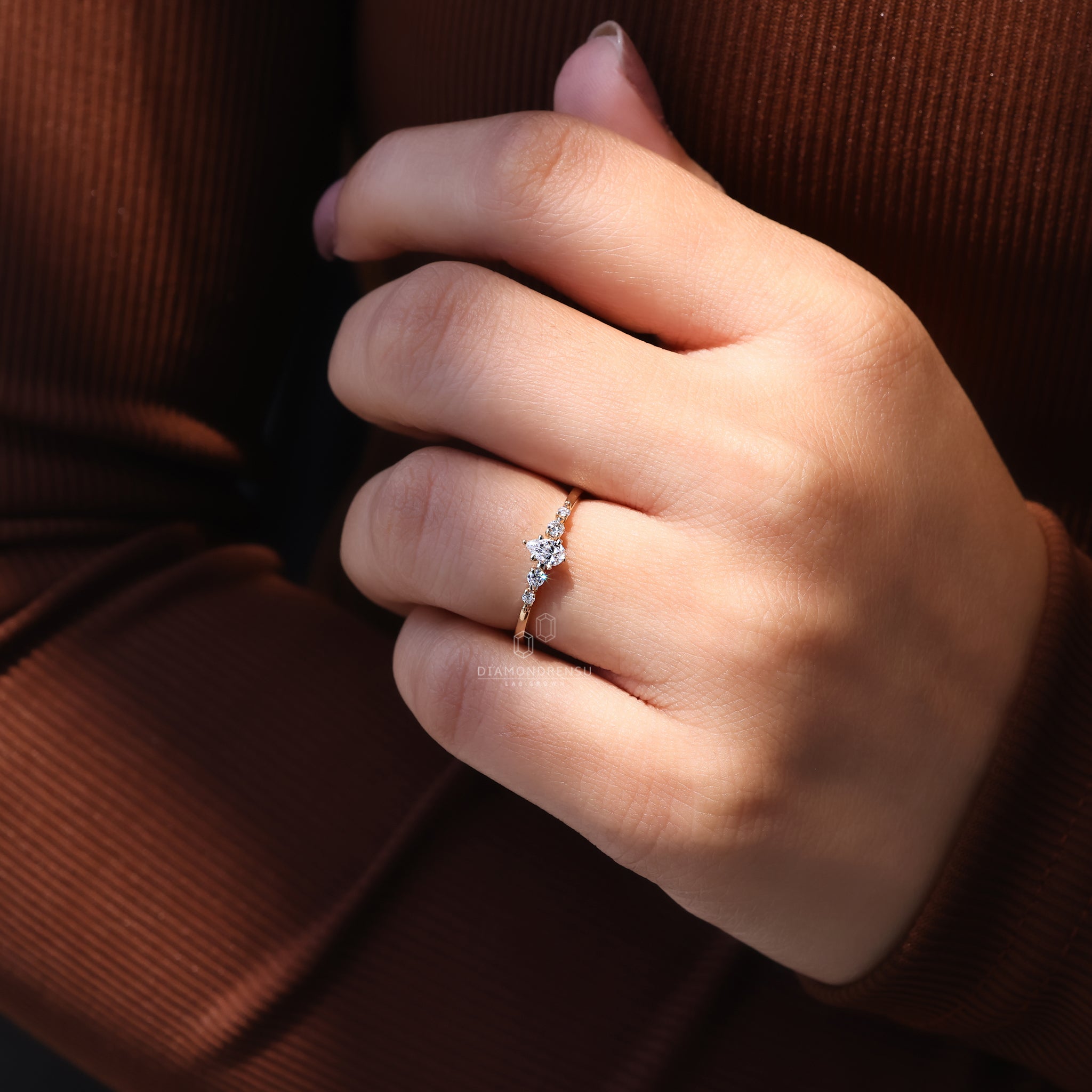 Lab grown pear cut diamond ring with shared prong setting