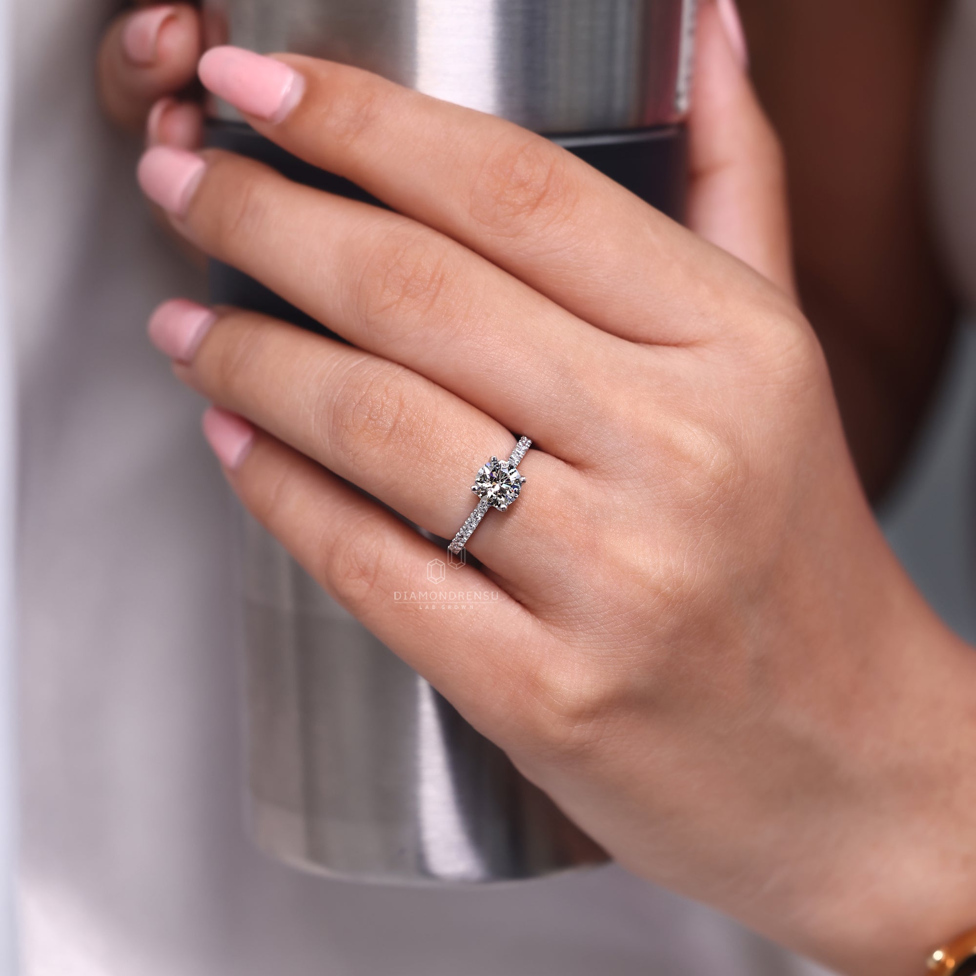 White gold ring with round cut center.