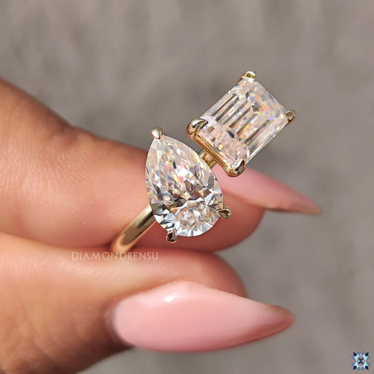 Custom engagement ring with toi et moi pear and emerald cuts.