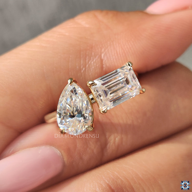 Moissanite engagement ring with claw prong toi et moi setting.