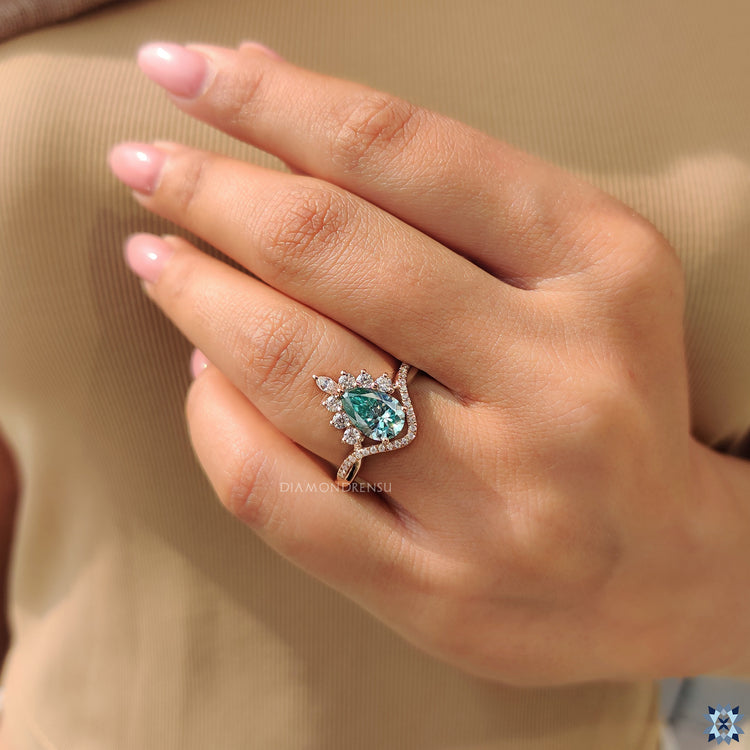 Pear cut Moissanite ring in prong setting with halo design.