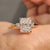 Three stone ring featuring radiant cut moissanite and round side stones.
 Three stone ring featuring radiant cut moissanite and round side stones.