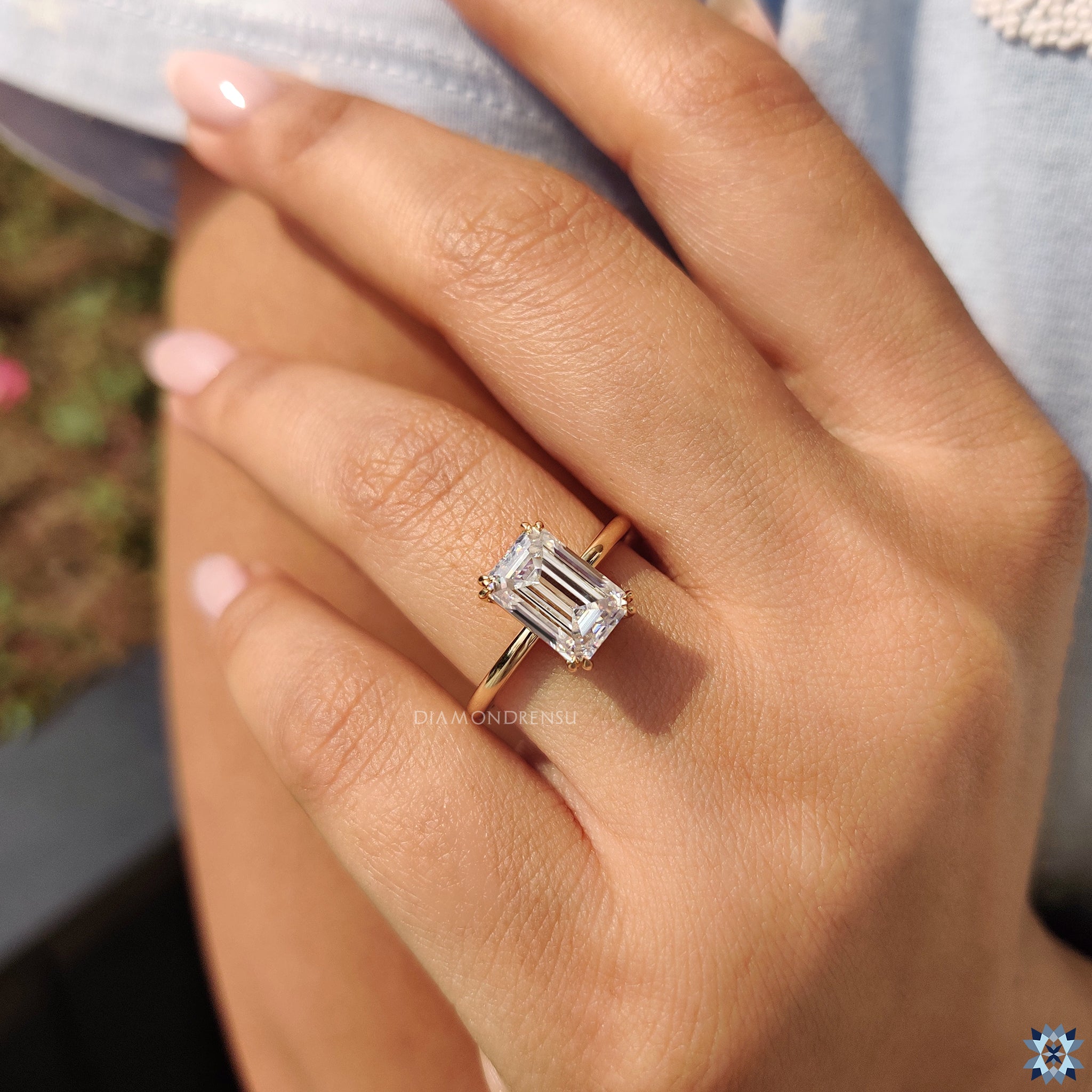 Handmade jewellery showcasing emerald cut moissanite in solitaire prong mount.