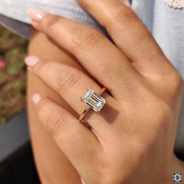 Handmade jewellery showcasing emerald cut moissanite in solitaire prong mount.
