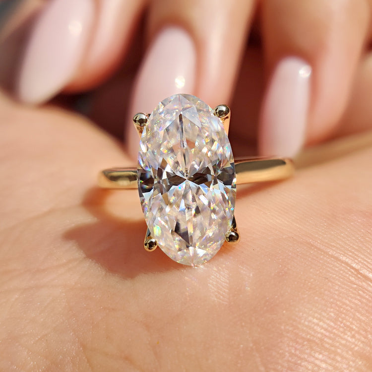 Moval Cut Engagement Ring with yellow gold ring