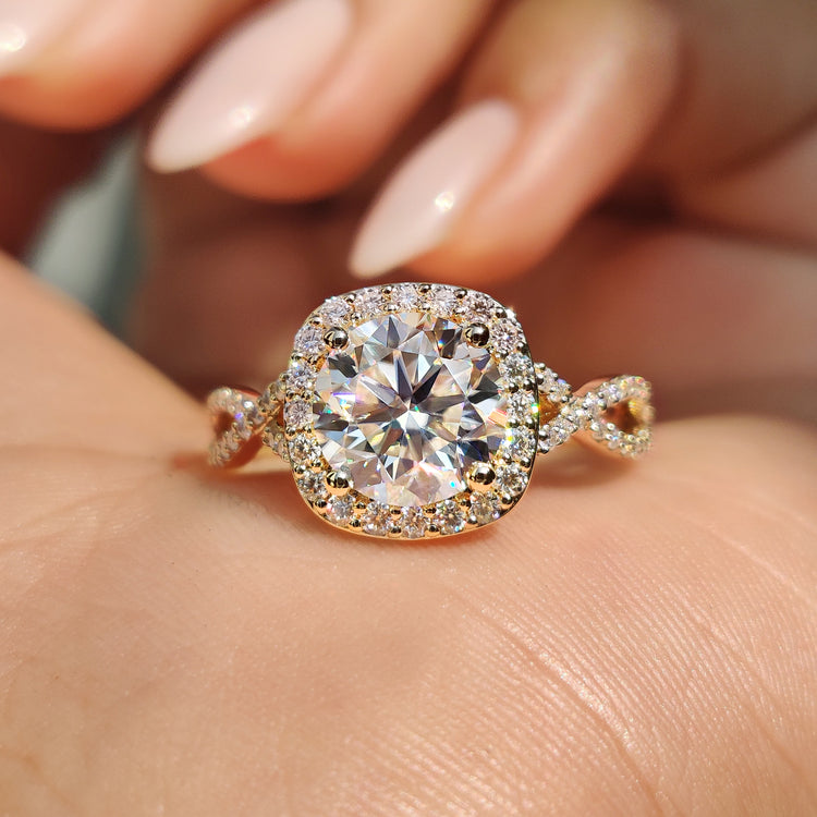 Round cut moissanite ring with twisted pave band in yellow gold.