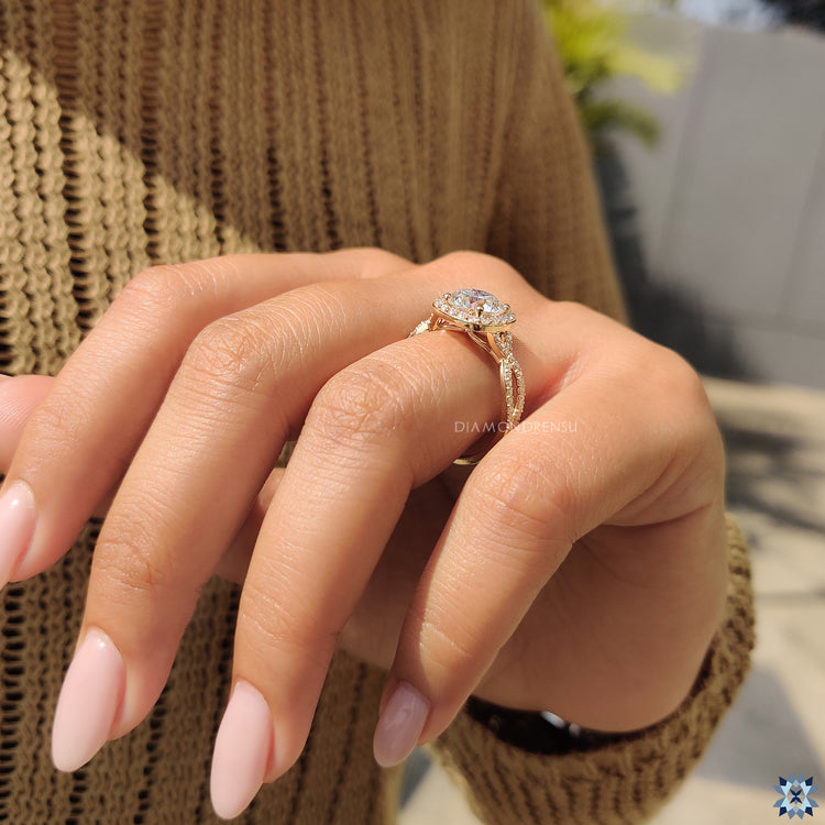Handmade ring featuring round cut moissanite and twisted pave halo design.
