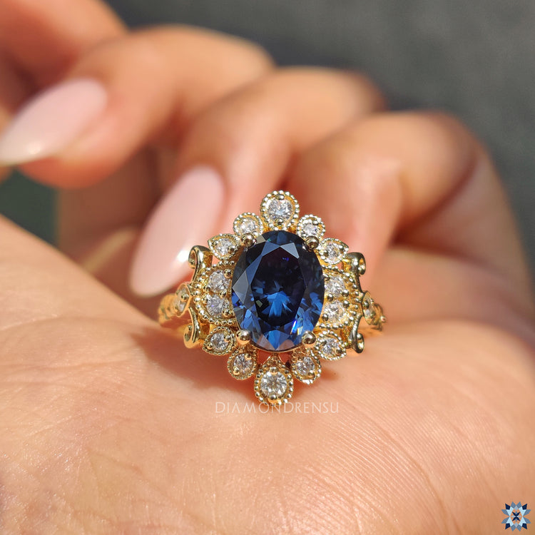 Round cut halo ring featuring blue round moissanite and peekaboo detail.