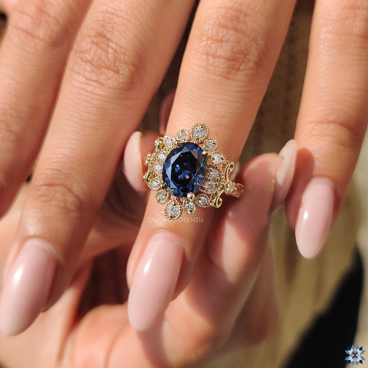 Yellow gold ring with handmade blue moissanite in round cut style.