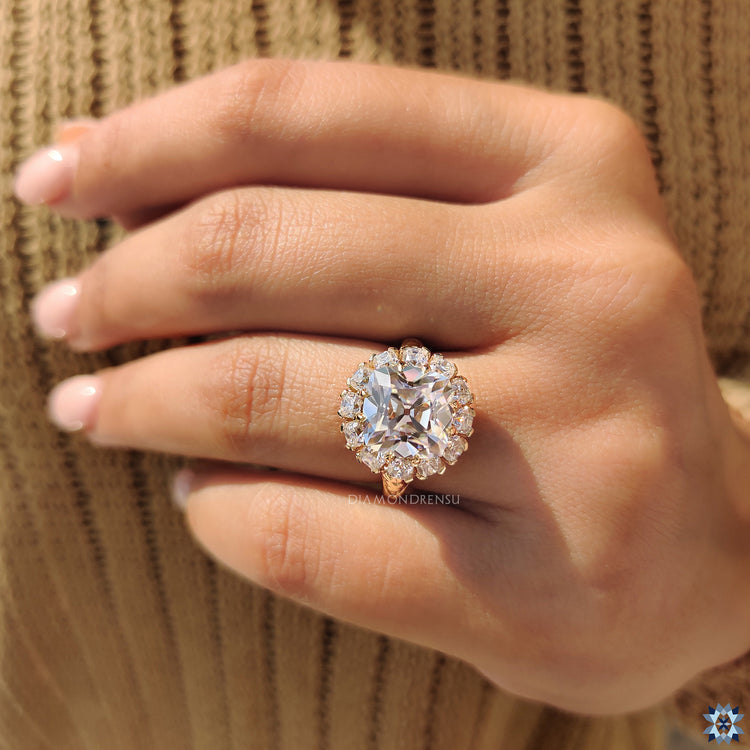 Custom engagement ring featuring cushion old mine cut stone.