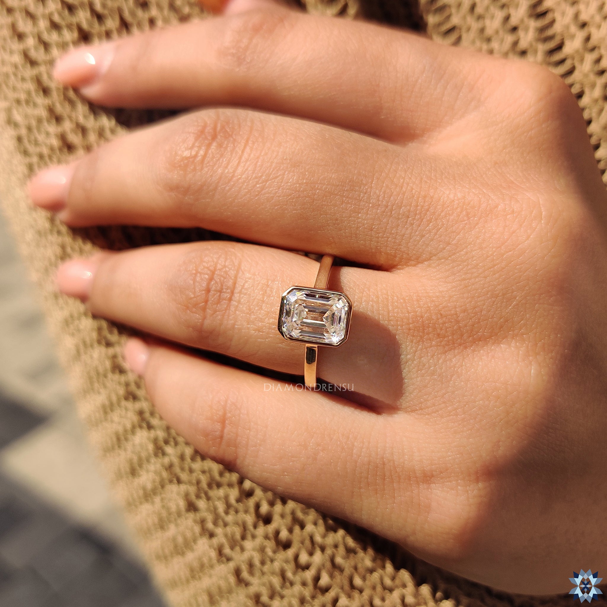 Bezel set engagement ring in emerald cut ring style