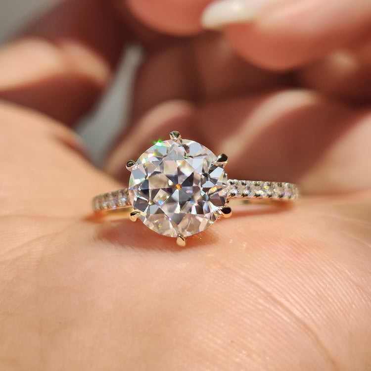 Moissanite pave ring in yellow gold with a round old European cut centre.