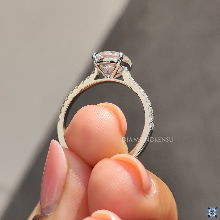 Buy engagement ring with cathedral setting and moissanite brilliance.