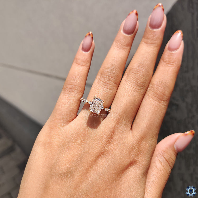Handmade cushion cut moissanite ring with pave band and marquise-round side stones.