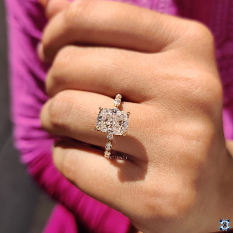 Crushed ice cushion moissanite ring in yellow gold with elegant hidden halo setting.