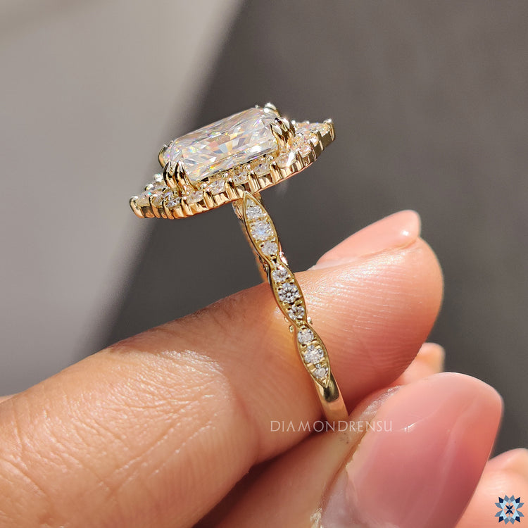 Radiant halo engagement ring with Art Deco styling and round pave diamonds.