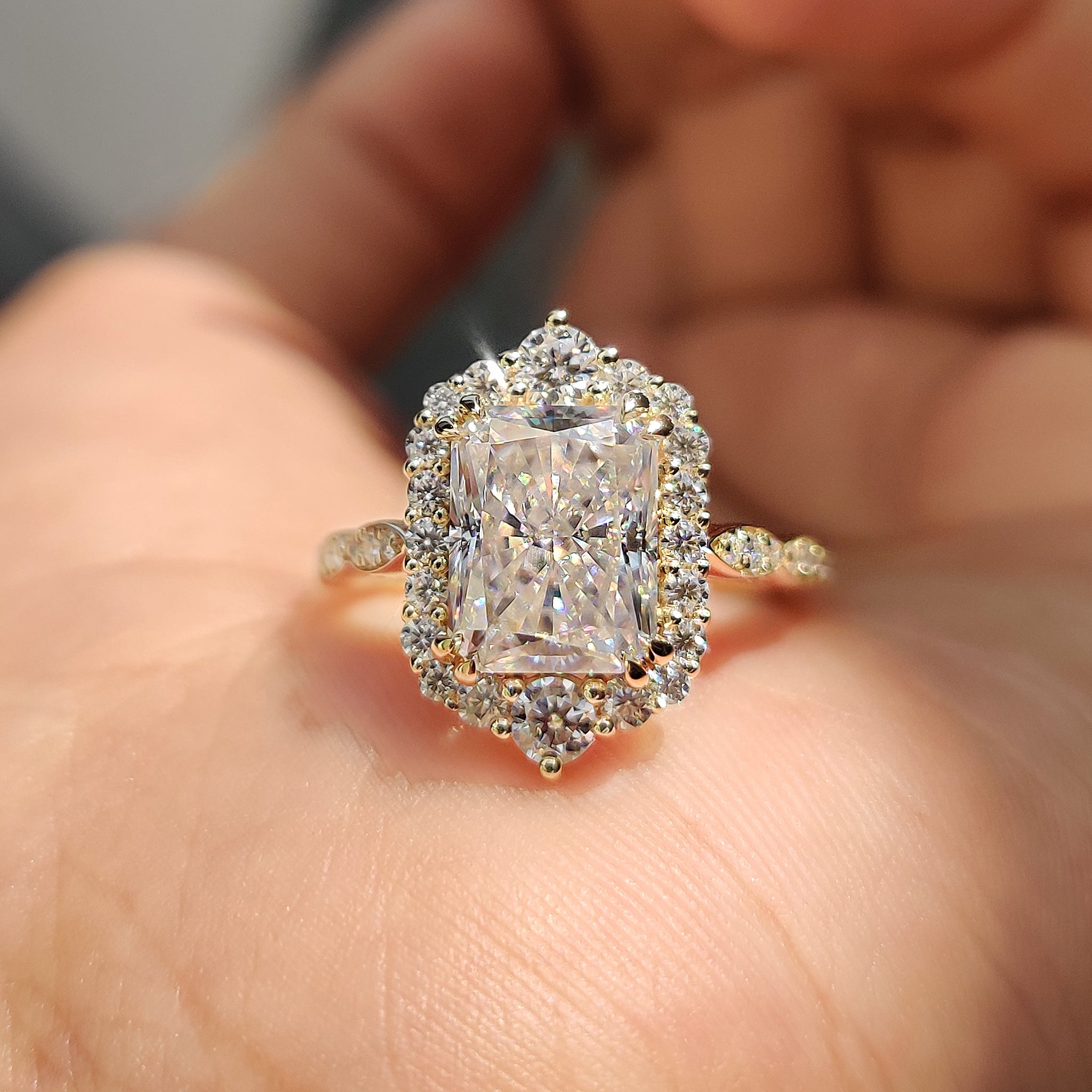 Radiant halo engagement ring with vintage milgrain detailing and yellow gold band.