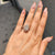 Round cut halo setting with pave band in a radiant moissanite engagement ring.
 Round cut halo setting with pave band in a radiant moissanite engagement ring.
