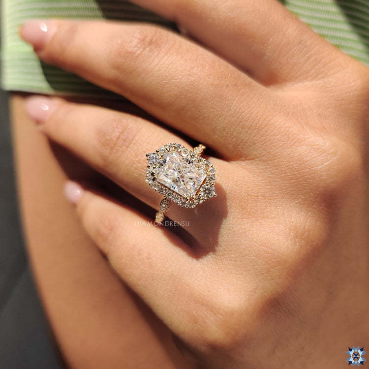 Round prong setting and radiant cut moissanite in handmade engagement ring.