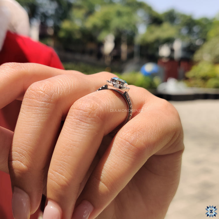 Buy engagement ring with cyan blue moissanite and elegant halo detail.